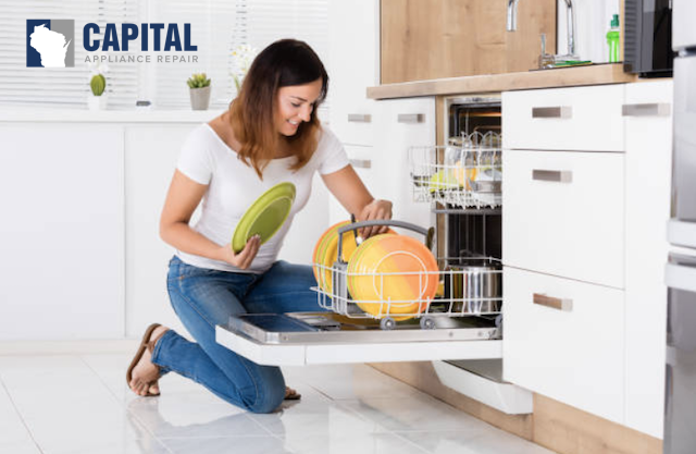 woman using dishwasher
